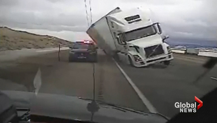 wind gust pushes tractor trailer onto police patrol car watch news